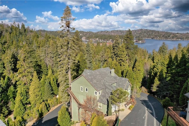 aerial view featuring a water view and a wooded view