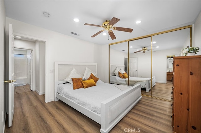 bedroom with recessed lighting, a closet, visible vents, wood finished floors, and baseboards