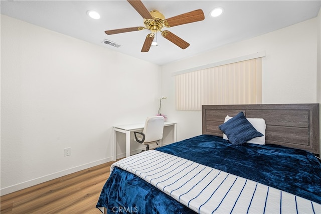 bedroom with baseboards, visible vents, a ceiling fan, wood finished floors, and recessed lighting