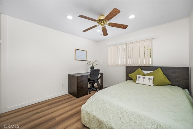 bedroom with a ceiling fan, baseboards, wood finished floors, and recessed lighting