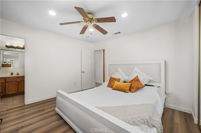 bedroom featuring visible vents, baseboards, and wood finished floors