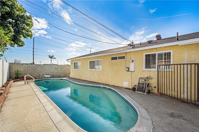 view of swimming pool with a diving board, a patio area, a fenced backyard, and a fenced in pool