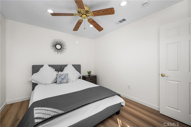 bedroom with baseboards, visible vents, wood finished floors, and recessed lighting