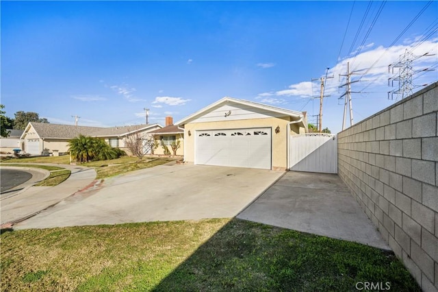 exterior space featuring an attached garage, a gate, fence, and concrete driveway