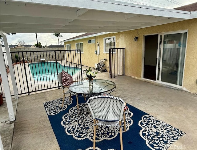 view of patio featuring fence and a fenced in pool