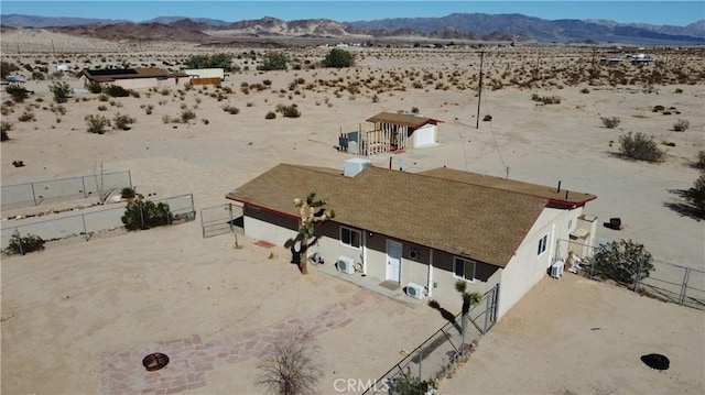 drone / aerial view featuring a desert view and a mountain view