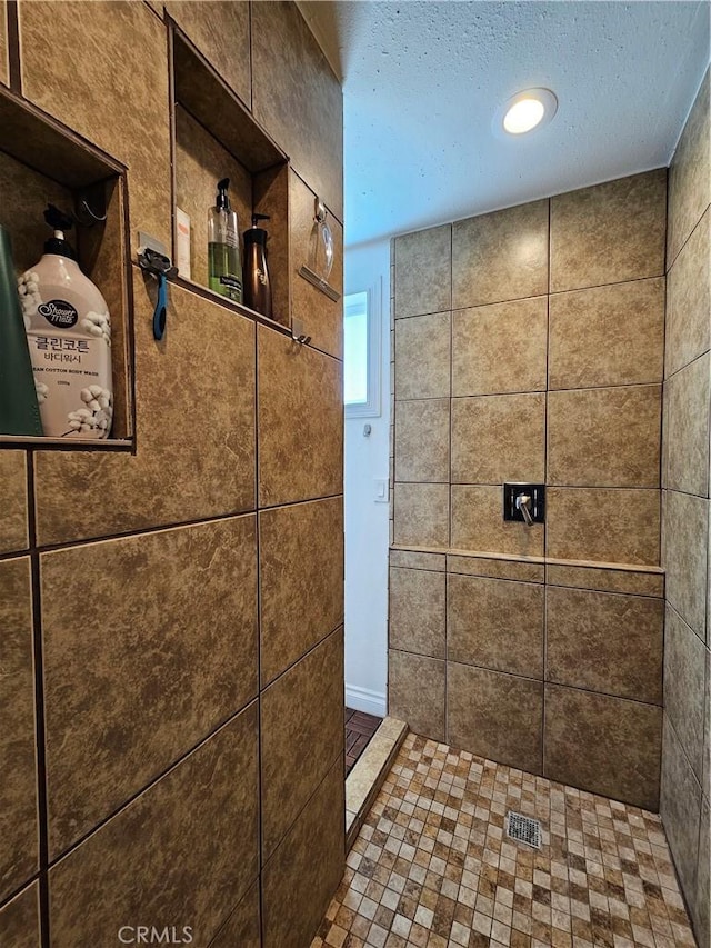 full bath featuring tiled shower