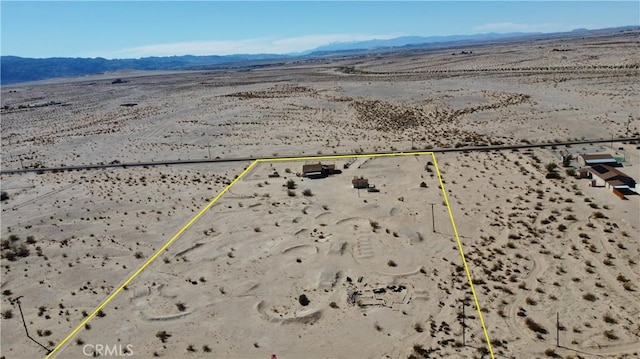 birds eye view of property featuring a mountain view and a desert view