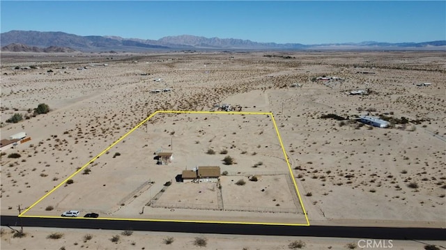 drone / aerial view featuring view of desert and a mountain view