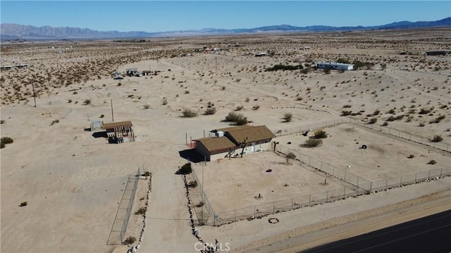 drone / aerial view featuring view of desert and a mountain view