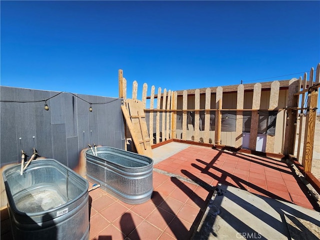 view of patio featuring a jacuzzi