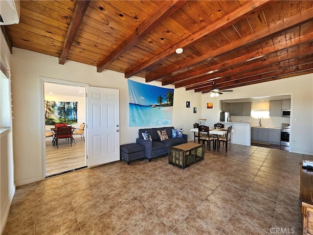 tiled living room with baseboards, wooden ceiling, ceiling fan, beamed ceiling, and a sink