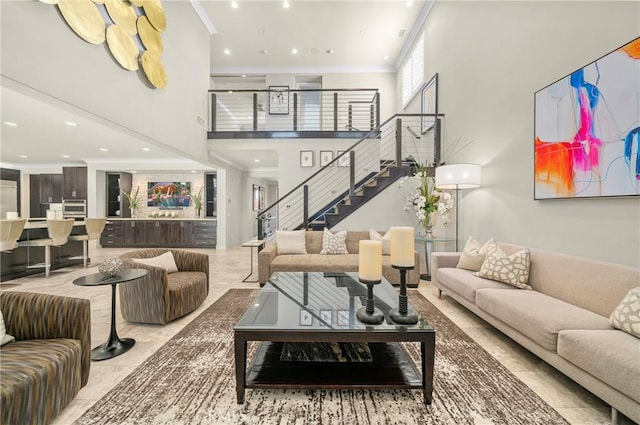 living room featuring stairway, recessed lighting, crown molding, and a towering ceiling