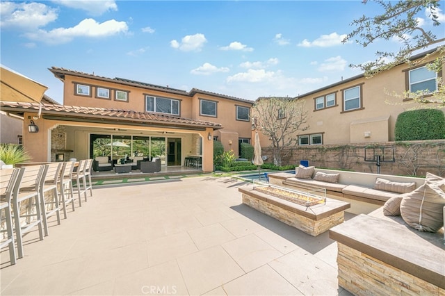 view of patio / terrace featuring an outdoor living space with a fire pit and an outdoor bar