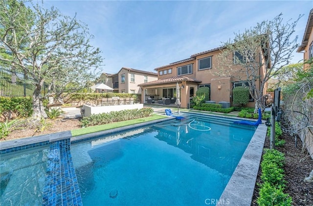 pool featuring a fenced backyard and a patio