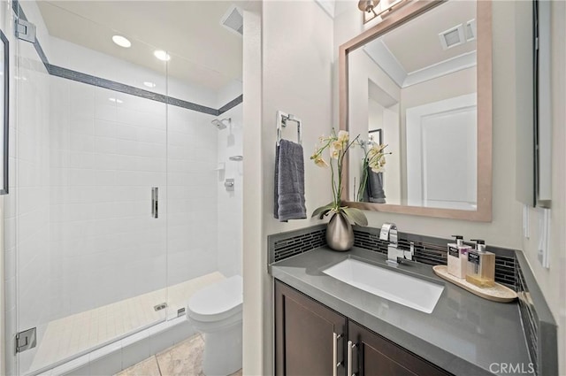 bathroom featuring toilet, a shower stall, visible vents, and vanity