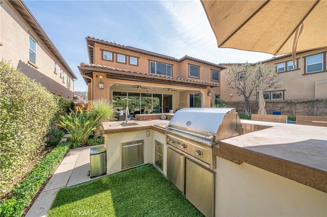 view of patio / terrace featuring a fenced backyard, exterior kitchen, and area for grilling