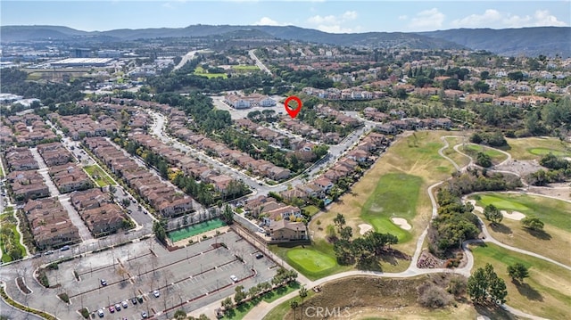 birds eye view of property with a mountain view and golf course view