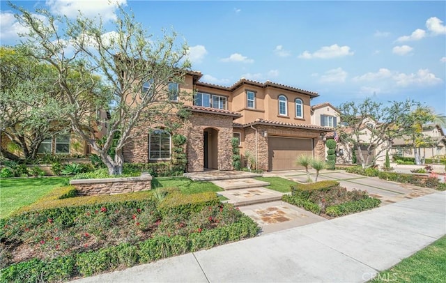 mediterranean / spanish house featuring stucco siding, concrete driveway, a garage, stone siding, and a tile roof