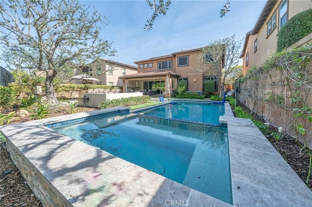 view of pool with a pool with connected hot tub and a fenced backyard