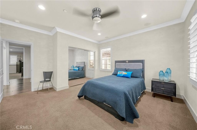 carpeted bedroom with baseboards, a ceiling fan, crown molding, a closet, and recessed lighting