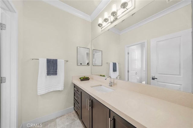 bathroom with baseboards, ornamental molding, and vanity