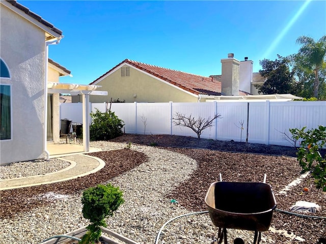 view of yard with a patio area, a fenced backyard, and a pergola