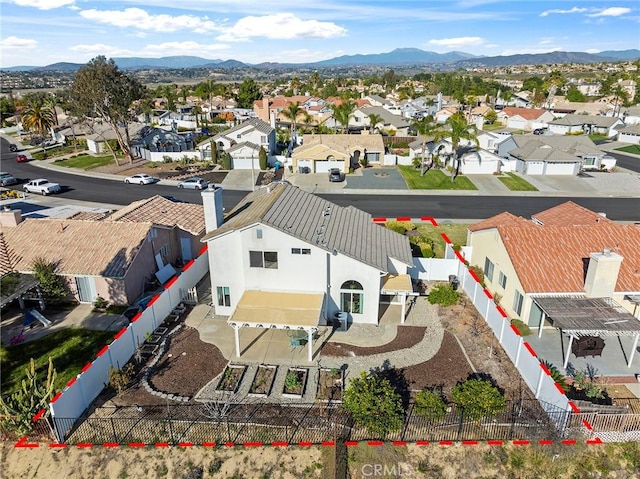 birds eye view of property featuring a mountain view and a residential view