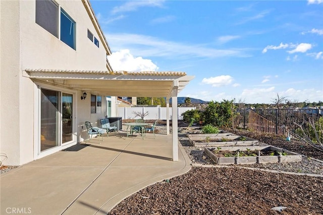 view of patio with a fenced backyard and a vegetable garden