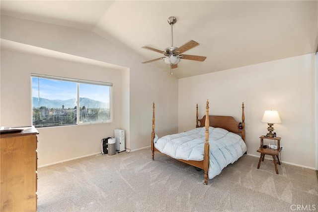 carpeted bedroom featuring a ceiling fan, lofted ceiling, and baseboards