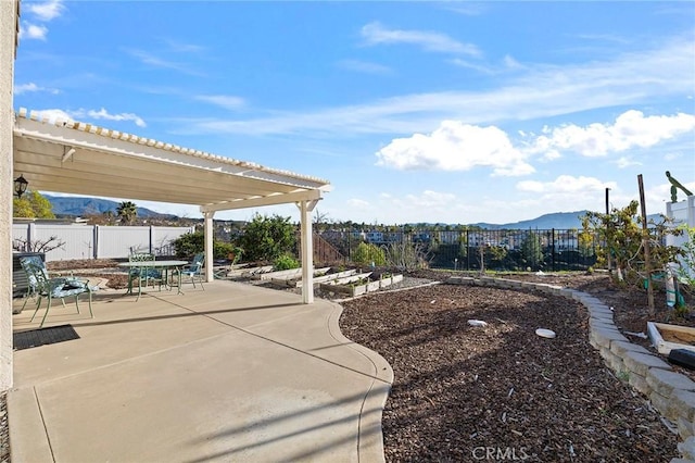 view of patio featuring a fenced backyard and a mountain view