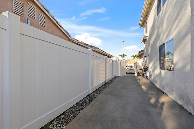 view of side of property featuring fence and stucco siding