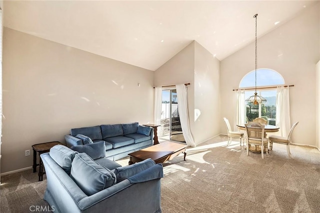 carpeted living room featuring baseboards, high vaulted ceiling, and a healthy amount of sunlight