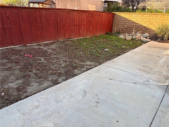 view of yard featuring fence private yard and a patio area