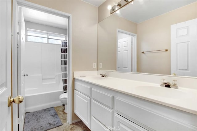 bathroom featuring double vanity, washtub / shower combination, toilet, and a sink