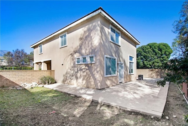 back of property featuring central AC, a patio area, a fenced backyard, and stucco siding