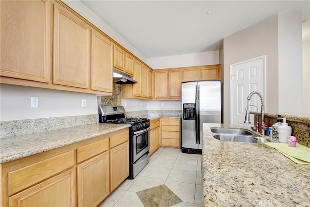 kitchen with light brown cabinets, appliances with stainless steel finishes, a sink, and under cabinet range hood