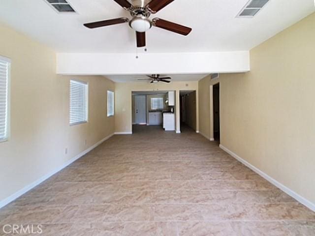 empty room with baseboards and visible vents