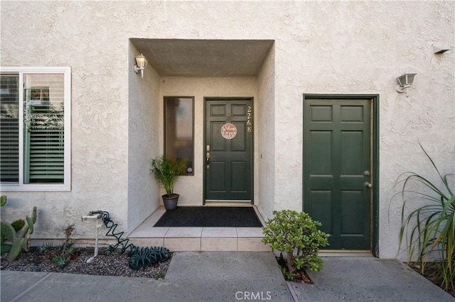 view of exterior entry with stucco siding