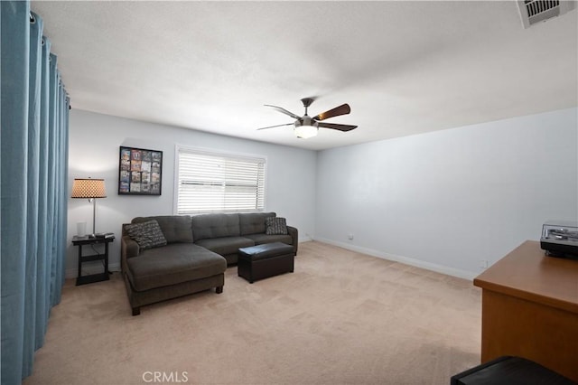 living room with light carpet, baseboards, visible vents, and a ceiling fan