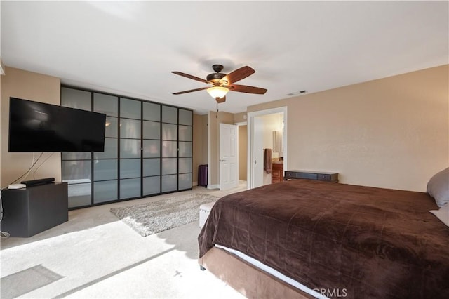 bedroom with a ceiling fan, visible vents, and light carpet