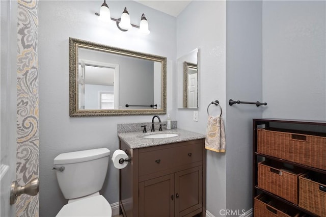 bathroom featuring toilet and vanity