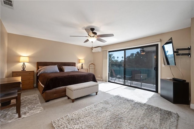 bedroom with access to exterior, visible vents, a wall unit AC, and a ceiling fan