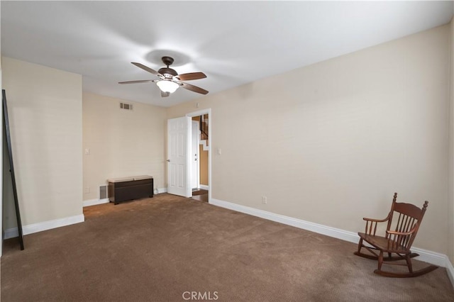 interior space with visible vents, dark carpet, and baseboards