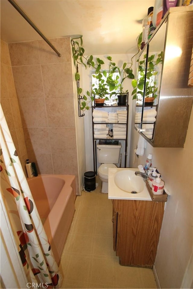 full bathroom with tile patterned floors, vanity, toilet, and shower / bathtub combination with curtain