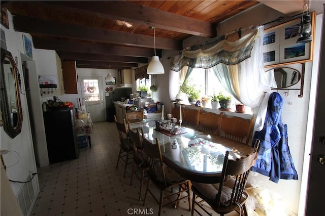 dining space featuring light floors, beam ceiling, and wood ceiling