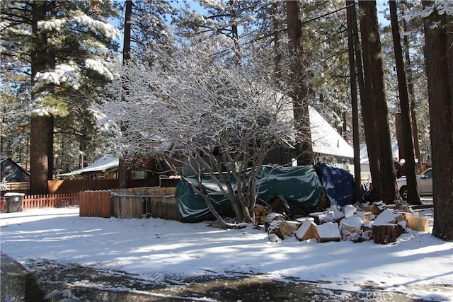 snowy yard with fence