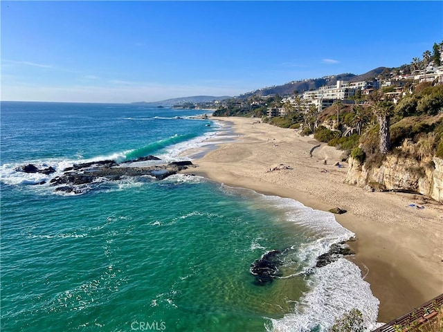 aerial view with a water view and a beach view