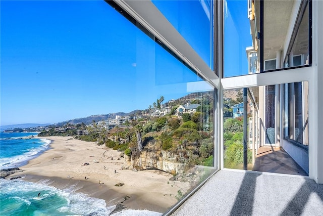 exterior space featuring a beach view and a water view