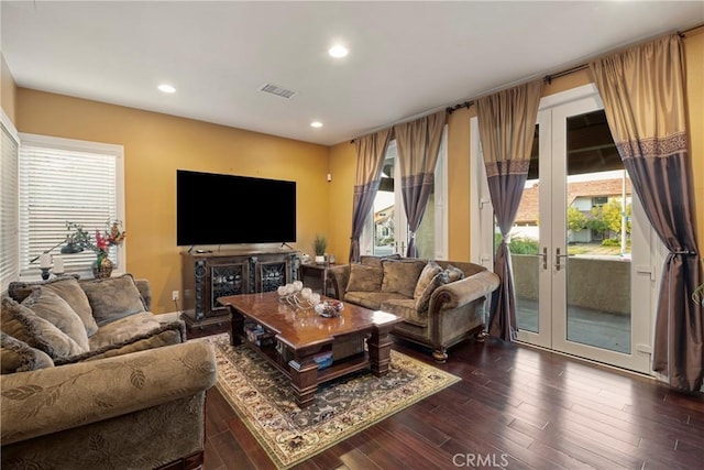 living area featuring recessed lighting, french doors, visible vents, and wood finished floors